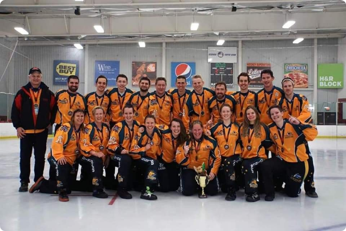 Australian broomball team celebrating their Worlds Mixed Challenge Cup victory